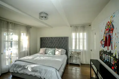 a bedroom with a large bed and some windows at Gorgeous Renovated 3BD 2BA near West Hollywood and Beverly Hills in Los Angeles