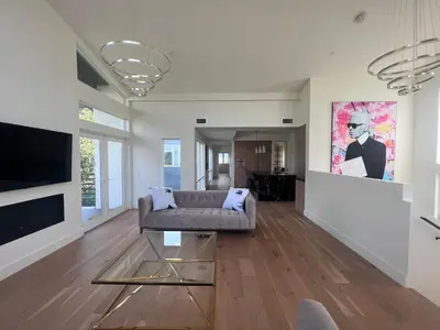 a living room with a couch and a tv at Gorgeous Private and Gated Home in Silver Lake with Pool & Views in Los Angeles