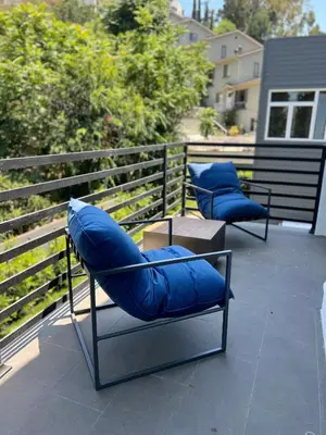 two blue chairs sitting on top of a balcony at Gorgeous Private and Gated Home in Silver Lake with Pool & Views in Los Angeles