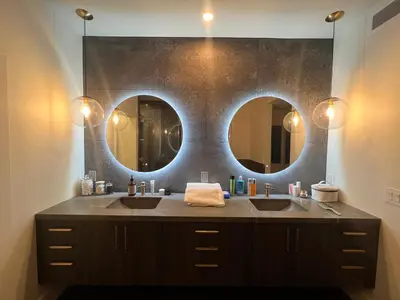 a bathroom with two sinks and two mirrors at Gorgeous Private and Gated Home in Silver Lake with Pool & Views in Los Angeles
