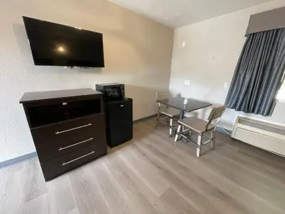 a small room with a table and a television at Villa Inn Anaheim in Anaheim