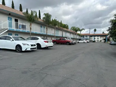 a group of cars parked in a parking lot at Villa Inn Anaheim in Anaheim