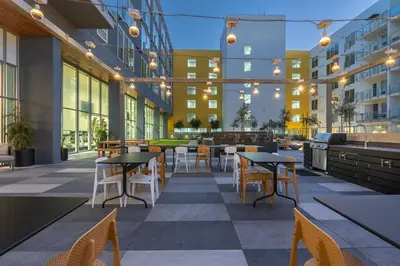 a patio with tables and chairs in a building at Level Long Beach - East Village in Long Beach