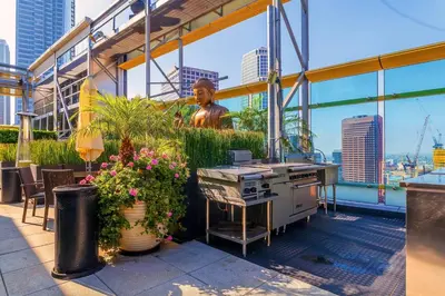 a rooftop patio with a grill and a statue at Downtown 1BR w Pool Gym WD nr Staples Center LAX-551 in Los Angeles