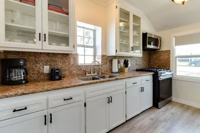 a kitchen with white cabinets and a sink at San Fernando Pool home + Large Private Guest House in San Fernando