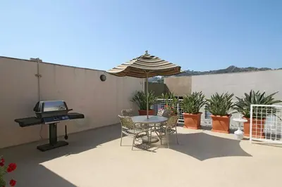 a patio with a table and an umbrella and a grill at Hollywood 1BR w Gym Pool Spa nr Sunset LAX-55 in Los Angeles