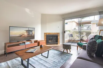 a living room with a large tv and a fireplace at Hollywood 1BR w Gym Spa Pool nr Metro LAX-52 in Los Angeles