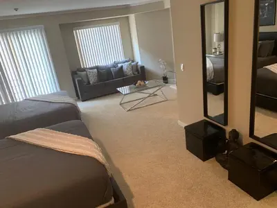 a room with a bed and a couch and a mirror at Hollywood loft spectacular free parking in Los Angeles