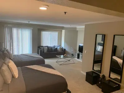 a hotel room with two beds and a couch at Hollywood loft spectacular free parking in Los Angeles