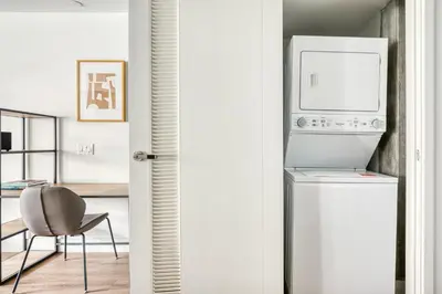 a kitchen with a refrigerator and a table and a chair at Downtown 1BR w Pool Gym WD nr Staples Center LAX-547 in Los Angeles
