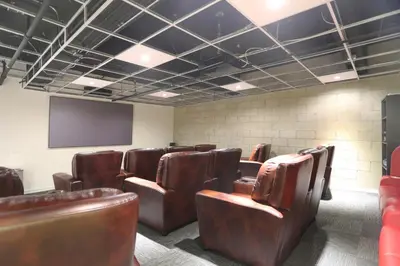 a conference room with leather chairs and a screen at Downtown 1BR w Pool Gym WD nr Staples Center LAX-547 in Los Angeles