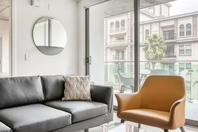 a living room with a couch and a chair at Downtown 1BR w Pool Gym WD nr Staples Center LAX-547 in Los Angeles