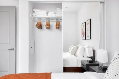 a bedroom with a bed and a closet with towels at Culver City 1br w roof lounge gym nr 405 LAX-925 in Los Angeles