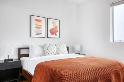 a bedroom with a bed with a orange blanket at Culver City 1br w roof lounge gym nr 405 LAX-925 in Los Angeles
