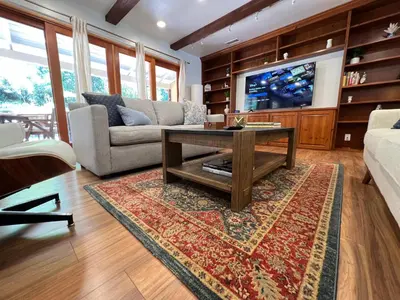 a living room with a couch and a coffee table at Villa La Reforma - Newly Designed 4BR HOUSE & POOL in Los Angeles by Topanga in Los Angeles