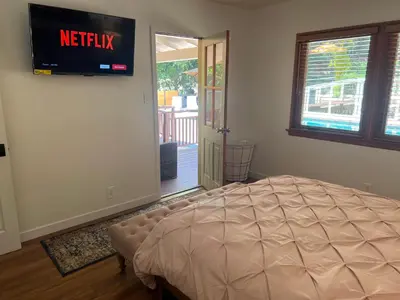 a bedroom with a bed and a television on the wall at Villa La Reforma - Newly Designed 4BR HOUSE & POOL in Los Angeles by Topanga in Los Angeles