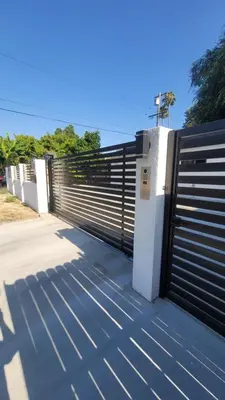 a black and white fence with a gate at Gated private house with own parking Sherman Oaks in Los Angeles