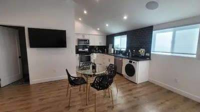 a kitchen with a glass table and chairs in a room at Gated private house with own parking Sherman Oaks in Los Angeles