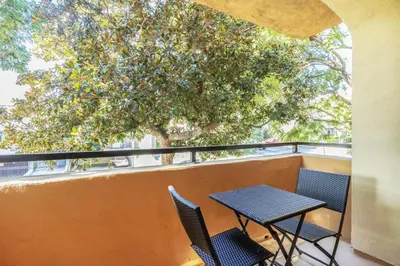a table and chairs on a balcony with a tree at W Hollywood 1BR nr Shops Melrose LAX-210 in Los Angeles