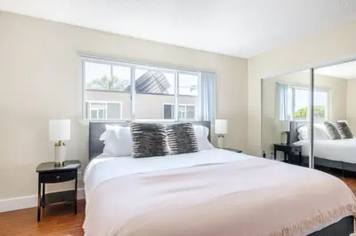 a bedroom with a large white bed and two windows at Marina Del Rey 1BR nr marina shops dining LAX-467 in Los Angeles