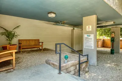 a building with a bench and stairs with a sign at Pasadena 1BR w Gym Pool nr Colorado Ave LAX-862 in Pasadena