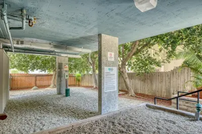 an empty parking lot with a fence and trees at Pasadena 1BR w Gym Pool nr Colorado Ave LAX-862 in Pasadena