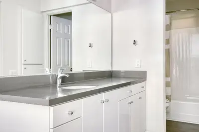 a white bathroom with a sink and a mirror at Burbank 1BR w Pool WD Gym nr TJ WF LAX-788 in Los Angeles