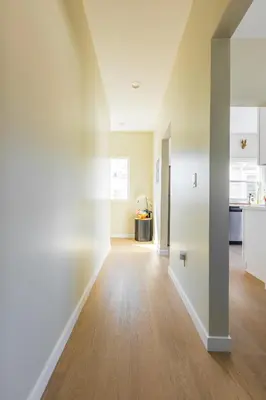 an empty living room with white walls and wood floors at Cozy Sunny Brand-new Apt 1 Block From The Beach in Long Beach