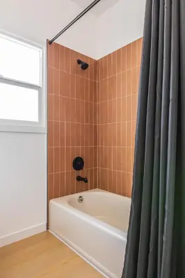 a bathroom with a tub and a shower curtain at Cozy Sunny Brand-new Apt 1 Block From The Beach in Long Beach