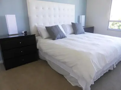 a bedroom with a large white bed and a dresser at Masterpiece 2-Bedroom with Balcony, Pool, and Spa in Los Angeles