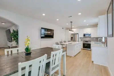 a kitchen and dining room with a table and chairs at Pet-Friendly Paramount Home, 16 Mi to Los Angeles! in Paramount