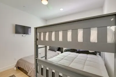a bedroom with a bunk bed and a tv at Pet-Friendly Paramount Home, 16 Mi to Los Angeles! in Paramount