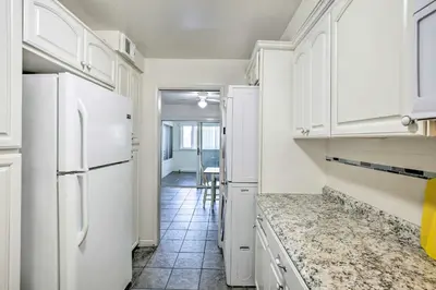 a kitchen with white cabinets and a counter top at 1 Mi to SoFi! Convenient Inglewood Condo in Inglewood