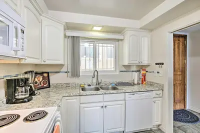 a kitchen with white cabinets and a sink at 1 Mi to SoFi! Convenient Inglewood Condo in Inglewood