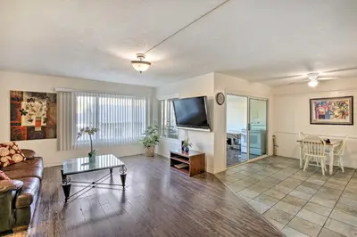 a living room with a couch and a table at 1 Mi to SoFi! Convenient Inglewood Condo in Inglewood