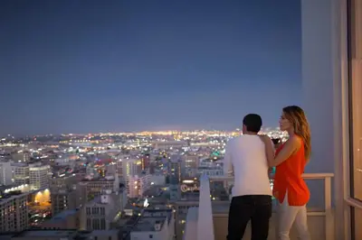 a man and a woman standing on top of a building at Level Downtown LA South Olive in Los Angeles
