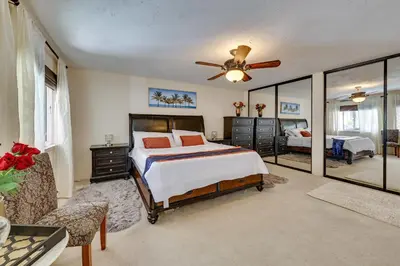 a bedroom with a bed and a ceiling fan at Spacious Apple Valley Home with Pool and Yard! in Apple Valley
