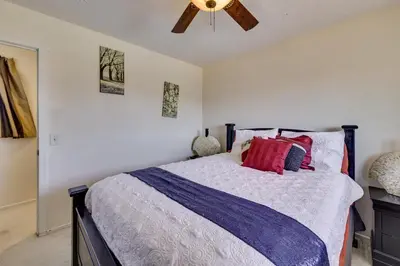 a bedroom with a bed and a ceiling fan at Spacious Apple Valley Home with Pool and Yard! in Apple Valley