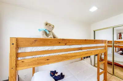 two stuffed animals sitting on top of a bunk bed at Edelwiess Wonder in Crestline