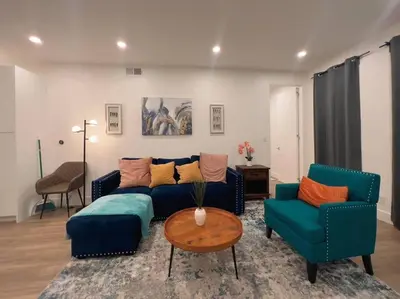a living room with a couch and two chairs and a table at Luminousness 4B3B Home in Torrance