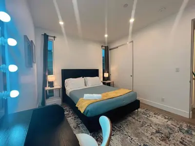 a small bedroom with a bed and a table at Luminousness 4B3B Home in Torrance