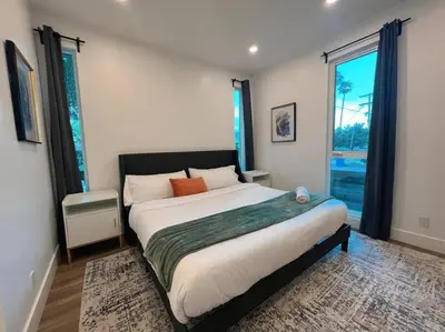 a bedroom with a large bed and a large window at Luminousness 4B3B Home in Torrance