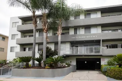 a building with palm trees in front of it at Brentwood 1BR w Outdoor Pool nr UCLA Downtown LAX-188 in Los Angeles