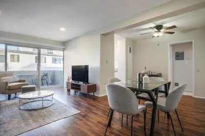 a living room with a table and chairs and a television at Brentwood 1BR w Outdoor Pool nr UCLA Downtown LAX-188 in Los Angeles
