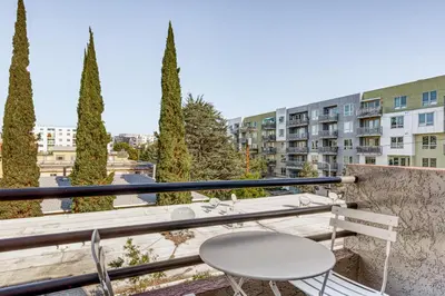 a balcony with a table and chairs and a building at N Hollywood 2BR w Gym Pool nr TJ Shops LAX-591 in Los Angeles