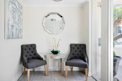 two chairs sitting next to a table with a mirror at Beverly Hills 2BR near the Grove Rodeo Drive LAX-866 in Los Angeles