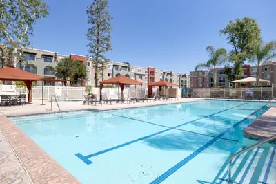 a large swimming pool with tables and umbrellas at Woodland Hills 2BR w Pool Gym nr Warner Center LAX-699 in Los Angeles