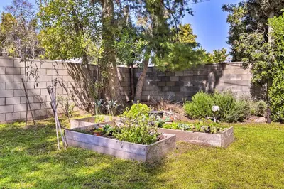 a garden with two raised beds in the grass at San Gabriel Valley Hideaway! Family Home with Patio in Temple City