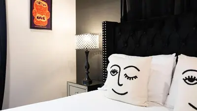 a bedroom with a bed with pillows withooky faces at Rock n Roll by AvantStay in Los Angeles