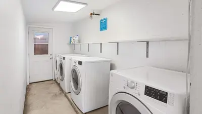 a laundry room with two washing machines and a window at Rock n Roll by AvantStay in Los Angeles